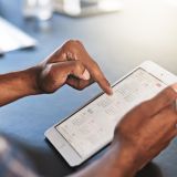 digital-planning-progress-cropped-shot-young-businessman-using-digital-tablet-office